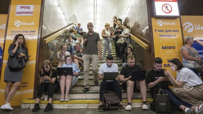 People take cover at metro station during a Russian rocket attack in Kyiv, Ukraine, Monday, May 29, 2023. Explosions have rattled Kyiv during daylight as Russian ballistic missiles fell on the Ukrainian capital. The barrage came hours after a more common nighttime attack of the city by drones and cruise missiles. (AP Photo/Evgeniy Maloletka)