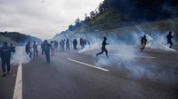 Polisi berusaha membubarkan aksi mereka dengan menembakan gas air mata.  