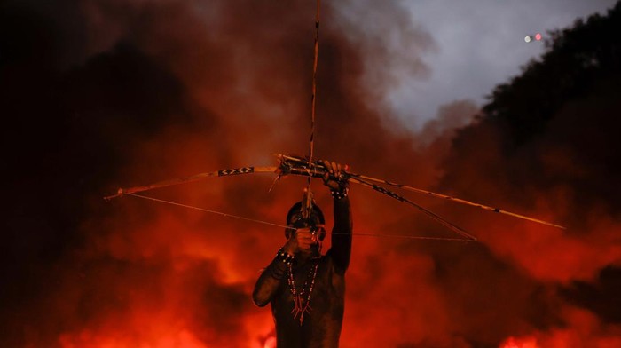 A member of Guarani Mbya Indigenous people protests against the so-called legal thesis of 