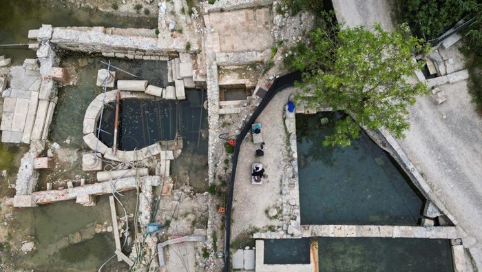 People enjoy thermal baths next to the ruins of an ancient spa where around 20 Etruscan and Roman bronze statues were discovered in San Casciano dei Bagni, a hilltop village in southern Tuscany still home to popular thermal baths, Italy, May 29, 2023. REUTERS/Guglielmo Mangiapane