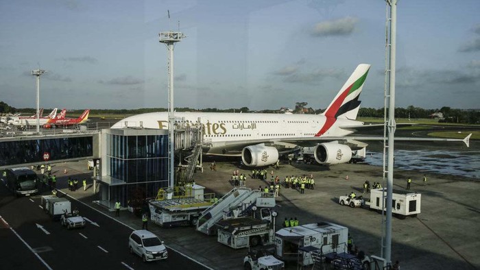 BALI, INDONESIA - JUNE 01: Airbus A380-800 operated by Emirates Airlines parked is seen after landing as airplane takes off in the back at Ngurah Rai International Airport in Kuta, Bali, Indonesia on June 1, 2023. The biggest passengers plane in the world which carries 460 passengers landed for the first time in Indonesia as part of to boost tourism industries in Bali and increase the international connectivity after pandemic era. The airplane will be used regularly for Denpasar-Dubai flight. (Photo by Johannes P. Christo/Anadolu Agency via Getty Images)