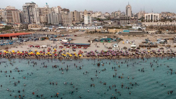 An aerial view shows Palestinians gathering on the beach in Gaza City on June 2, 2023, during a heat wave. (Photo by MOHAMMED ABED / AFP) (Photo by MOHAMMED ABED/AFP via Getty Images)