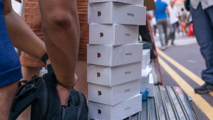 Boxes of the Apple Inc. iPhone XS, newly-purchased from shoppers, sit on an unauthorized resellers suitcase in Hong Kong, China, on Friday, Sept. 21, 2018. The iPhone XS is up to $200 more expensive than last years already pricey iPhone X and represents one of the smallest advances in the product lines history. But that means little to the Apple faithful or those seeking to upgrade their older iPhone. Photographer: Anthony Kwan/Bloomberg via Getty Images