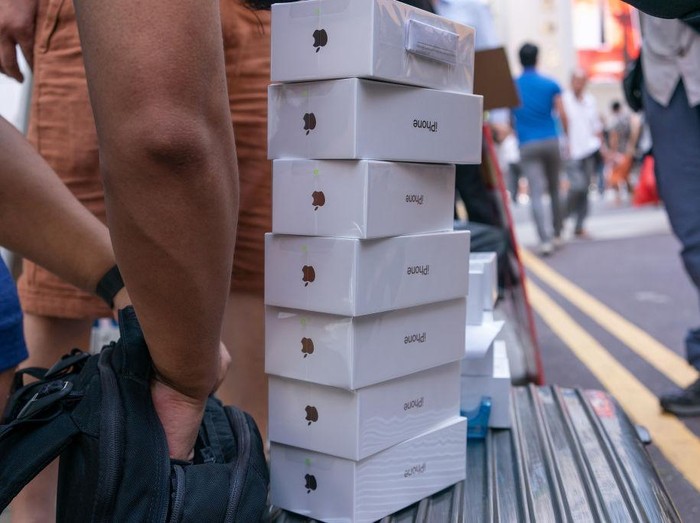 Boxes of the Apple Inc. iPhone XS, newly-purchased from shoppers, sit on an unauthorized resellers suitcase in Hong Kong, China, on Friday, Sept. 21, 2018. The iPhone XS is up to $200 more expensive than last years already pricey iPhone X and represents one of the smallest advances in the product lines history. But that means little to the Apple faithful or those seeking to upgrade their older iPhone. Photographer: Anthony Kwan/Bloomberg via Getty Images