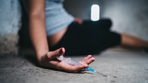 Young caucasian woman passed out after overdosed herself.