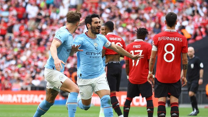 Soccer Football - FA Cup Final - Manchester City v Manchester United - Wembley Stadium, London, Britain - June 3, 2023 Manchester Citys Ilkay Gundogan celebrates scoring their second goal with John Stones REUTERS/Carl Recine