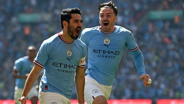 Manchester City's German midfielder Ilkay Gundogan celebrates with Manchester City's English midfielder Jack Grealish (R) after scoring the early opening goal during the English FA Cup final football match between Manchester City and Manchester United at Wembley stadium, in London, on June 3, 2023. (Photo by Glyn KIRK / AFP) / NOT FOR MARKETING OR ADVERTISING USE / RESTRICTED TO EDITORIAL USE (Photo by GLYN KIRK/AFP via Getty Images)