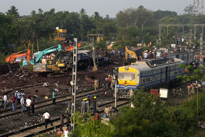 Policemen stand guard at the site where trains that derailed, in Balasore district, in the eastern Indian state of Orissa, Sunday, June 4, 2023. Indian authorities end rescue work and begin clearing mangled wreckage of two passenger trains that derailed in eastern India, killing over 300 people and injuring hundreds in one of the country’s deadliest rail crashes in decades. (AP Photo/Rafiq Maqbool)