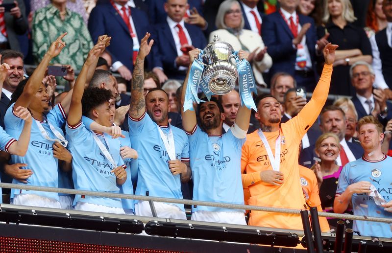 Soccer Football - FA Cup Final - Manchester City v Manchester United - Wembley Stadium, London, Britain - June 3, 2023 Manchester City's Ilkay Gundogan lifts the trophy alongside teammates as they celebrate after winning the FA Cup Action Images via Reuters/Paul Childs