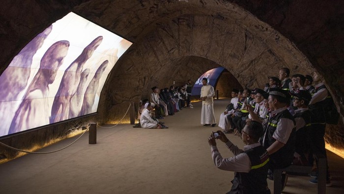 Pengunjung mengamati layar yang menceritakan sejarah para nabi saat mengunjungi Museum Wahyu, di Hira Cultural Distric, Mekkah, Arab Saudi, Jumat (2/6/2023). Museum Wahyu yang terletak di kaki Gunung Jabal Nur atau Gua Hiro yang menampilkan animasi turunnya wahyu serta kisah Nabi Adam, Nabi Nuh, Nabi Musa, Nabi Isa hingga Nabi Muhammad tersebut menjadi destinasi wisata sejarah di Kota Mekkah. ANTARA FOTO/Wahyu Putro/nym.