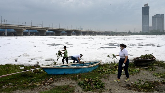 Warga India Ramai-ramai Bersihkan Sungai Berbusa Penuh Limbah dan Racun NOIDA, INDIA JUNE 4: A day before the World Environment Day, people along with different groups clean the Yamuna River near Kalindi Kunj during the 'Yamuna Sansad' initiative, on June 4, 2023 in Noida, India. (Photo by Sunil Ghosh/Hindustan Times via Getty Images)