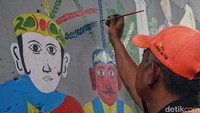 Sosok Ondel-ondel terlihat dari mural yang dilukis pasukan oranye.