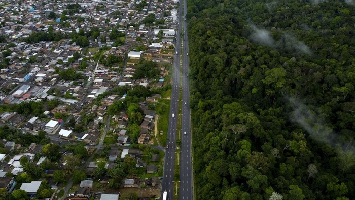 Aerial view of the Adolpho Ducke Forest Reserve, part of Amazonia rainforest, side by side with houses of the neighborhood Cidade de Deus (City Of God) located in the east zone of Manaus, Amazonas state, Brazil on June 5, 2023, during the World Environment Day. (Photo by MICHAEL DANTAS / AFP) (Photo by MICHAEL DANTAS/AFP via Getty Images)