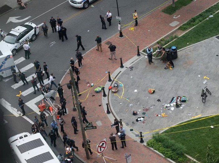Law enforcement officers investigate at the scene after a gunman opened fire in a park as high school graduates and their families emerged from a theater where commencement exercises had just concluded, in Richmond, Virginia, U.S. June 6, 2023 in this picture obtained from social media. Clark Frierson/Instagram @by.esign/via REUTERS