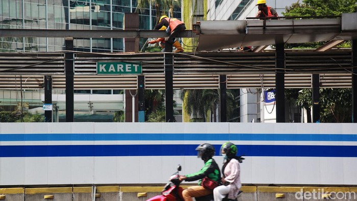 Halte Darurat TransJakarta Saat Revitalisasi Penumpang ngetap kartu pembayaran non cash Bus TransJakarta di Karet 2 Jakarta, Rabu (7/6/2023). PT Transportasi Jakarta (TransJakarta) menyediakan fasilitas Layanan TransJakarta sebagai pengganti halte yang sedang dalam proses revitalisasi. Layanan TransJakarta itu tampak terlihat sederhana dengan adanya banner sebagai penunjuk informasi dengan mesin tap. Selain itu, pembatas halte hanya diberi garis pembatas kecil.