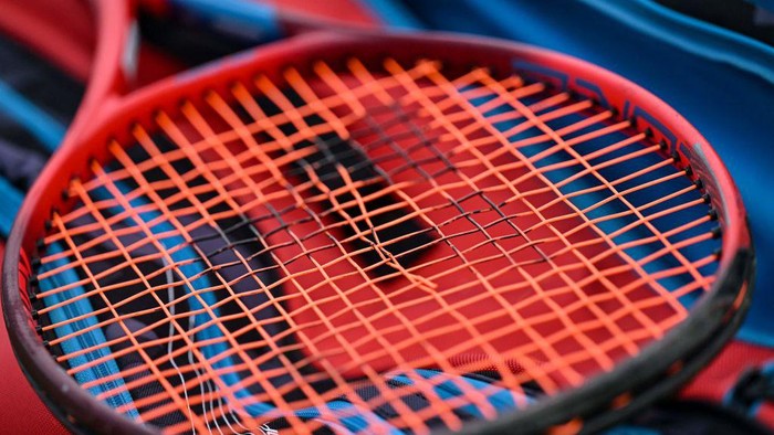 A racket with the broken strings is pictured on the seventh day of the 2022 Wimbledon Championships at The All England Tennis Club in Wimbledon, southwest London, on July 3, 2022. - RESTRICTED TO EDITORIAL USE (Photo by Glyn KIRK / AFP) / RESTRICTED TO EDITORIAL USE (Photo by GLYN KIRK/AFP via Getty Images)