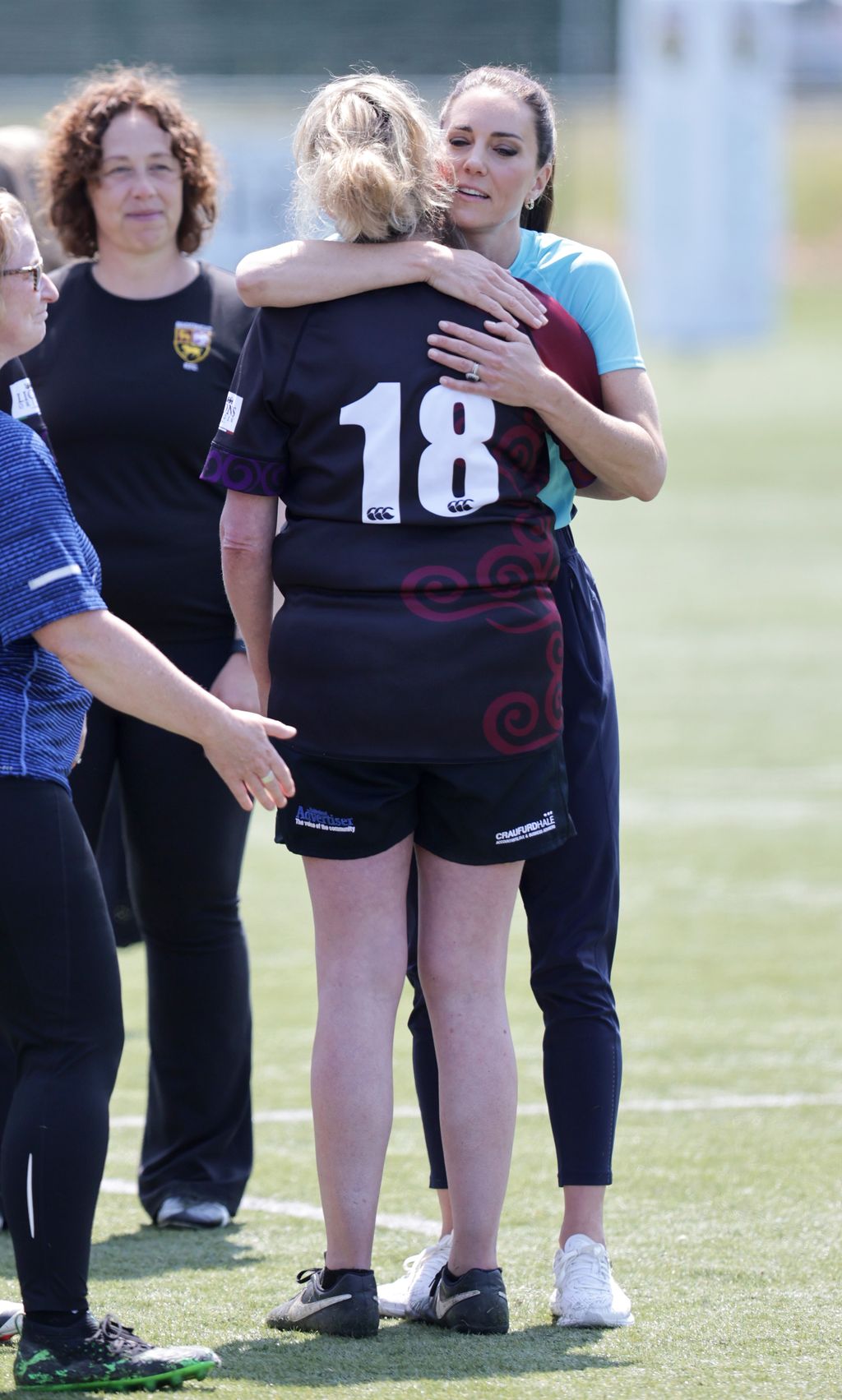 Kate Middleton Main Rubgy MAIDENHEAD, ENGLAND - JUNE 07: Catherine, Princess of Wales hugs a player during her visit to Maidenhead Rugby Club on June 07, 2023 in Maidenhead, England. The Princess of Wales is visiting the rugby club to discuss the Shaping Us campaign and the role the community plays in supporting children. (Photo by Chris Jackson/Getty Images)