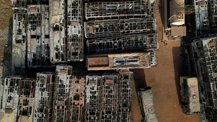 Burnt-out buses which belong to a partly state-funded 