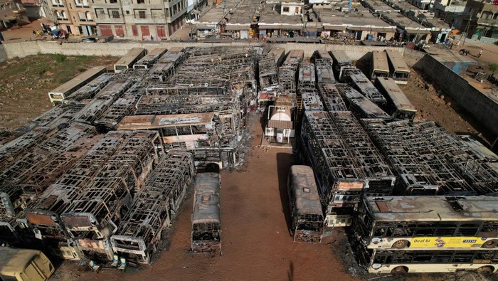 Burnt-out buses which belong to a partly state-funded 