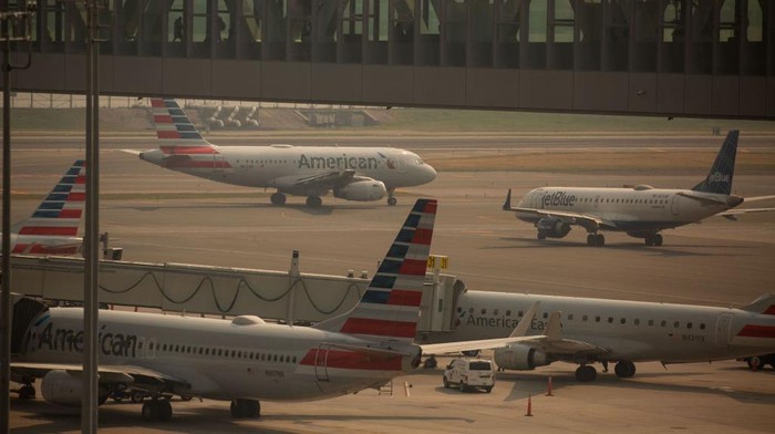 JetBlue and American Airlines planes at LaGuardia Airport (LGA) in the Queens borough of New York, US, on Thursday, June 8, 2023. The Federal Aviation Administration said LaGuardia Airport flights have now been placed under a ground delay program after being grounded due to poor visibility. Photographer: Michael Nagle/Bloomberg via Getty Images