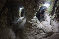 A tourist walks through a passage in the Derinkuyu underground city, in Turkeys central Nevsehir province, on August 24, 2022. - The ancient city of Elengubu, known today as Derinkuyu, reaches the depth of 85m below the Earths surface, and could accommodate up to 20,000 people. (Photo by OMAR HAJ KADOUR / AFP) (Photo by OMAR HAJ KADOUR/AFP via Getty Images)