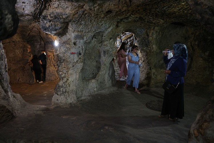 A tourist walks through a passage in the Derinkuyu underground city, in Turkeys central Nevsehir province, on August 24, 2022. - The ancient city of Elengubu, known today as Derinkuyu, reaches the depth of 85m below the Earths surface, and could accommodate up to 20,000 people. (Photo by OMAR HAJ KADOUR / AFP) (Photo by OMAR HAJ KADOUR/AFP via Getty Images)