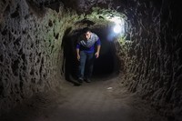 A tourist walks through a passage in the Derinkuyu underground city, in Turkeys central Nevsehir province, on August 24, 2022. - The ancient city of Elengubu, known today as Derinkuyu, reaches the depth of 85m below the Earths surface, and could accommodate up to 20,000 people. (Photo by OMAR HAJ KADOUR / AFP) (Photo by OMAR HAJ KADOUR/AFP via Getty Images)