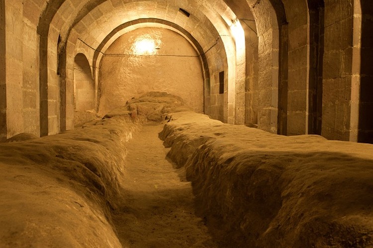 A tourist walks through a passage in the Derinkuyu underground city, in Turkeys central Nevsehir province, on August 24, 2022. - The ancient city of Elengubu, known today as Derinkuyu, reaches the depth of 85m below the Earths surface, and could accommodate up to 20,000 people. (Photo by OMAR HAJ KADOUR / AFP) (Photo by OMAR HAJ KADOUR/AFP via Getty Images)