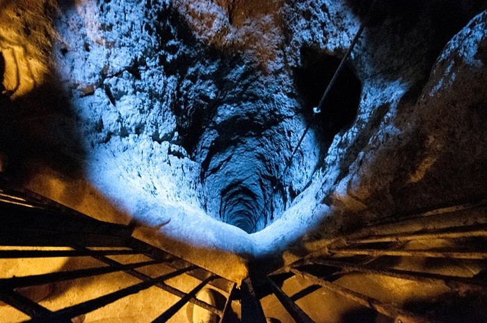 A tourist walks through a passage in the Derinkuyu underground city, in Turkeys central Nevsehir province, on August 24, 2022. - The ancient city of Elengubu, known today as Derinkuyu, reaches the depth of 85m below the Earths surface, and could accommodate up to 20,000 people. (Photo by OMAR HAJ KADOUR / AFP) (Photo by OMAR HAJ KADOUR/AFP via Getty Images)