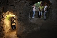 A tourist walks through a passage in the Derinkuyu underground city, in Turkeys central Nevsehir province, on August 24, 2022. - The ancient city of Elengubu, known today as Derinkuyu, reaches the depth of 85m below the Earths surface, and could accommodate up to 20,000 people. (Photo by OMAR HAJ KADOUR / AFP) (Photo by OMAR HAJ KADOUR/AFP via Getty Images)
