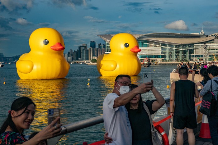HONG KONG, CHINA - JUNE 09: Giant inflatable rubber duck sculptures are seen in Victoria Harbor on June 09, 2023 in Hong Kong, China. The 18-metre-tall inflatable sculptures are some of the tallest rubber ducks in the world, created by Dutch artist Florentijn Hofman as part of a large-scale public art exhibition 