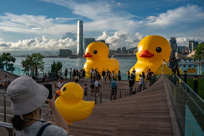 HONG KONG, CHINA - JUNE 09: Giant inflatable rubber duck sculptures are seen in Victoria Harbor on June 09, 2023 in Hong Kong, China. The 18-metre-tall inflatable sculptures are some of the tallest rubber ducks in the world, created by Dutch artist Florentijn Hofman as part of a large-scale public art exhibition 