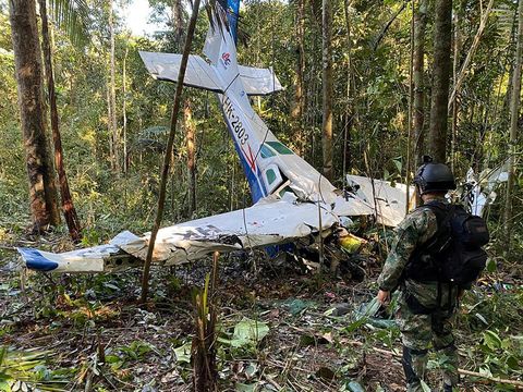 A soldier stands next to the wreckage of a plane during the search for child survivors from a Cessna 206 plane that crashed in the jungle more than two weeks ago in the jungles of Caqueta, Colombia May 19, 2023. Colombian Military Forces/Handout via REUTERS  ATTENTION EDITORS - THIS IMAGE WAS PROVIDED BY A THIRD PARTY. MANDATORY CREDIT. NO RESALES. NO ARCHIVES