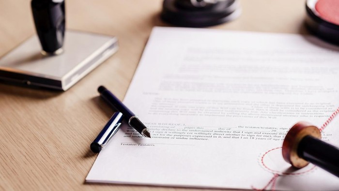 Notary pen lying on testament. Notary public working accesories