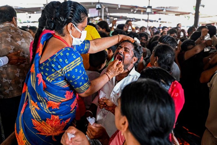 A patient swallows live murrel fish with herbs to cure asthma as administered by the Bathini Goud family, at the exhibition grounds in Hyderabad on June 9, 2023. (Photo by Noah SEELAM / AFP) (Photo by NOAH SEELAM/AFP via Getty Images)