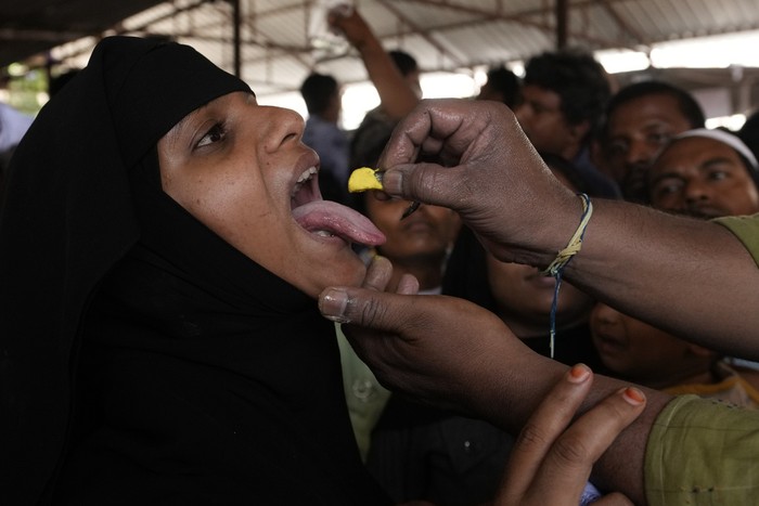 An asthma patient is administered a traditional fish medicine in Hyderabad, India, Friday, June 9, 2023. Every year thousands of asthma patients arrive here to receive this fish therapy from the Bathini Goud family, a secret formula of herbs, handed down by generations only to family members. The herbs are inserted in the mouth of a live sardine, or murrel fish, and slipped into the patient's throat. (AP Photo/Mahesh Kumar A.)