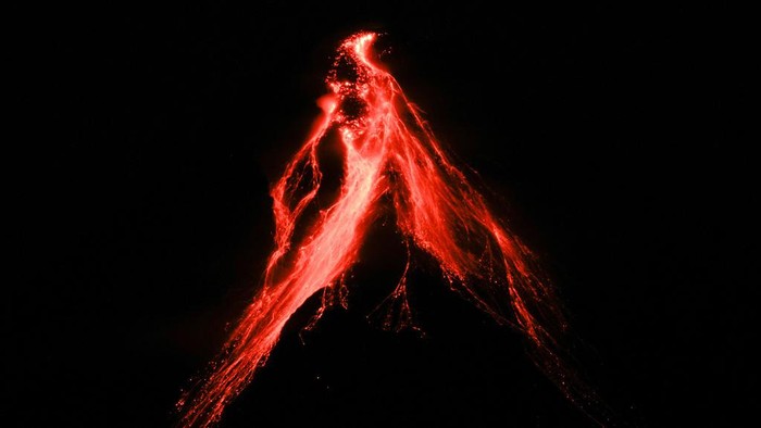 Gunung Berapi Paling Aktif di Filipina Erupsi, Ribuan Warga Mengungsi Mayon volcano belches red-hot emissions down it's slope as seen from Legaspi, Albay province, northeastern Philippines, Sunday, June 11, 2023. Albay was placed under a state of calamity last week to allow more rapid disbursement of emergency funds in case a major eruption unfolds. (AP Photo/Aaron Favila)