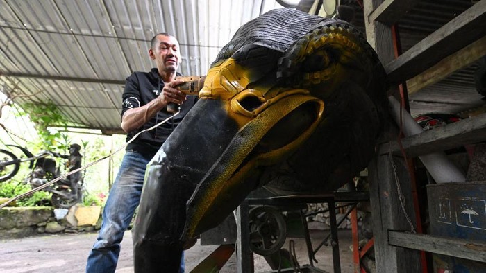 Colombian artist Edison Camacho shows his sculpture made with recycled materials at the Tire Museum in San Francisco de Sales, Cundinamarca department, Colombia, on March 31, 2023. - The museum was born as a family business and began as an exhibition of sculptures made with recycled material as tires to raise awareness in society about environmental pollution and transform garbage into art. (Photo by Raul ARBOLEDA / AFP) (Photo by RAUL ARBOLEDA/AFP via Getty Images)