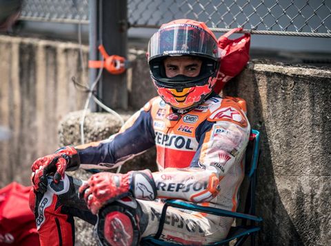 SCARPERIA, ITALY - JUNE 11: Marc Marquez of Spain and Repsol Honda Team sits in a chair after his crash next to the track marshals during the Race of the MotoGP Gran Premio d'Italia Oakley at Mugello Circuit on June 11, 2023 in Scarperia, Italy. (Photo by Steve Wobser/Getty Images)