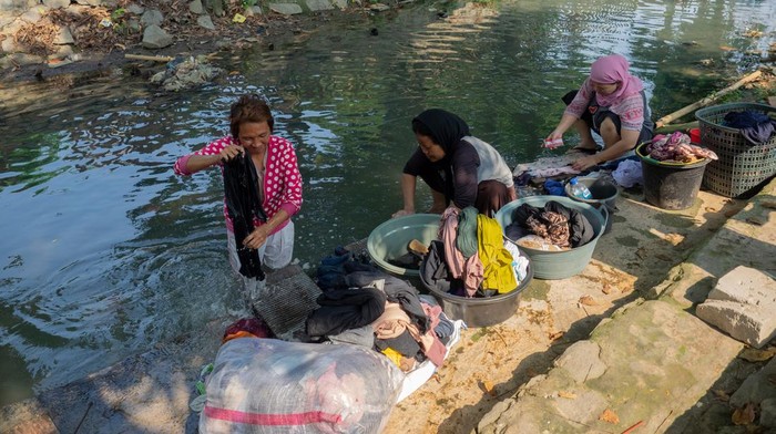In a bid to conserve clean water, a number of residents in Tangerang, Indonesia, were forced to utilize contaminated river water for washing their clothes on June 11, 2023. This measure was taken as an effort to minimize the consumption of clean water, which would otherwise require them to purchase two jerry cans at the cost of IDR7,000 for their daily needs, such as cooking and bathing. (Photo by Kevin Herbian/NurPhoto via Getty Images)