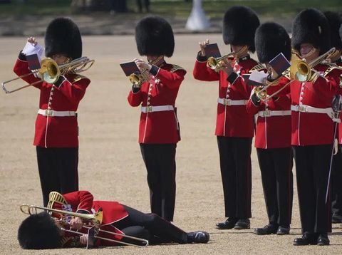 A trombone player in the military band faints during the Colonel's Review, the final rehearsal of the Trooping the Colour, the King's annual birthday parade, at Horse Guards Parade in London, Saturday, June 10, 2023. (Jonathan Brady/PA via AP)