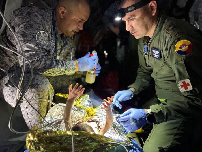 Soldiers of the Colombian Air Force give medical attention inside a plane to the surviving children of a Cessna 206 plane crash in the thick jungle, while they are transferred to Bogota by air in San Jose del Guaviare, Colombia, June 9, 2023. Colombian Air Force/Handout via REUTERS