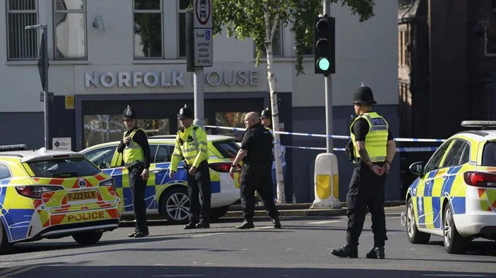 Police officers block a road in Nottingham, Britain, Tuesday, June 13, 2023. Police say the emergency services are responding to an “ongoing serious incident” in the central England city of Nottingham. Nottinghamshire Police said Tuesday that “there are multiple road closures in place throughout the city while the incident is being investigated.” (Jacob King/PA via AP)