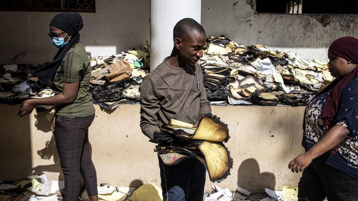 Archival and documentation students sift through burned documents at the Cheikh Anta Diop University in Dakar on June 09, 2023 in an effort to salvage them. Tens of thousands of student archives dating back to 1957 where burned during protest that broke out on June 01, 2023 after opposition leader Ousmane Sonko was sentenced to two years in prison. (Photo by JOHN WESSELS / AFP) (Photo by JOHN WESSELS/AFP via Getty Images)