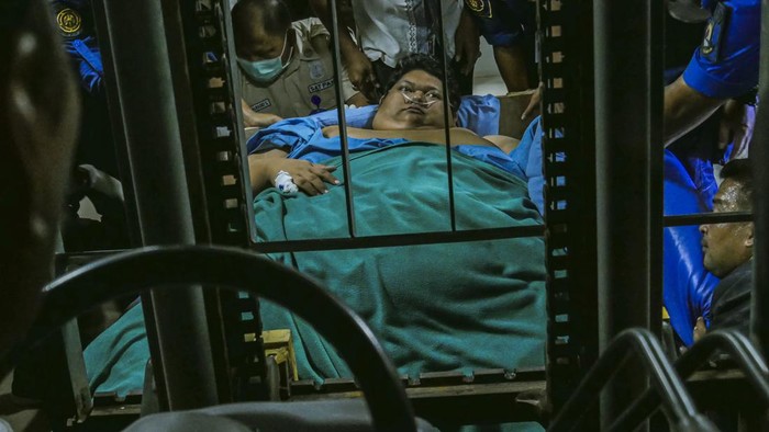 TANGERANG, INDONESIA : Firefighters together with the medical team carried out the transfer of Fajri (27), a  man weighing 300 kg, assisted by a forklift and a truck to be referred to Cipto Mangunkusumo Hospital at Tangerang City General Hospital, Banten. The transfer was carried out so that Fajri would receive intensive care and more complete medical equipment needed while undergoing treatment. (Photo credit should read Wawan Kurniawan/Jefta Images / Jefta Images/Future Publishing via Getty Images)
