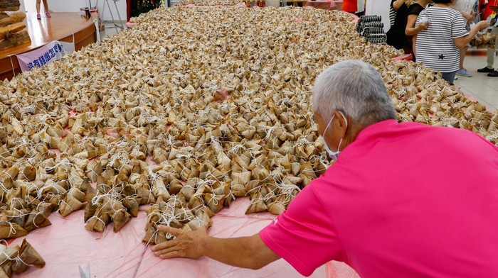 People gather to make traditional rice dumplings ahead of the annual Dragon boat festival in Taoyuan, Taiwan June 10, 2023. REUTERS/Ann Wang