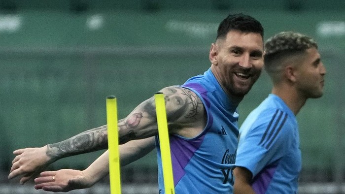 Lionel Messi reacts as he jogs with his teammates of Argentinas national soccer team as they practice one day ahead of their friendly soccer match against Australia in Beijing, Wednesday, June 14, 2023. (AP Photo/Andy Wong)