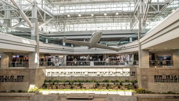 Denver, Colorado, May 30, 2022. Inside the Denver International airport, featuring an airplane and people on the ground level