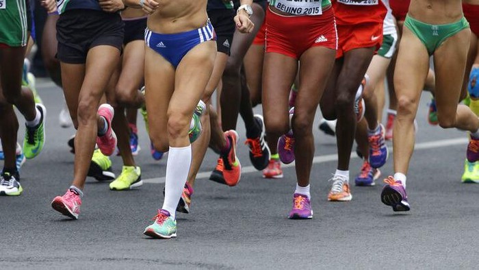 The coloured running shoes of competitors pound the ground near the start of the womens marathon at the World Athletic Championships at the Birds Nest stadium in Beijing, Sunday, Aug. 30, 2015. (AP Photo/Wong Maye-E)