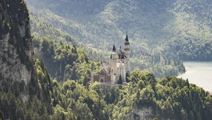 A view of the Neuschwanstein castle, in Schwangau, Germany, Thursday, June 15, 2023. Authorities say an American man has been arrested in Germany after allegedly assaulting two tourists he met near Neuschwanstein castle. The attack, which occurred on Wednesday, left one of the women dead. Police said Thursday that the 30-year-old man met the two women on a hiking path and lured them onto a trail. They said the man then “physically attacked” the younger woman. (Frank Rumpenhorst/dpa via AP)